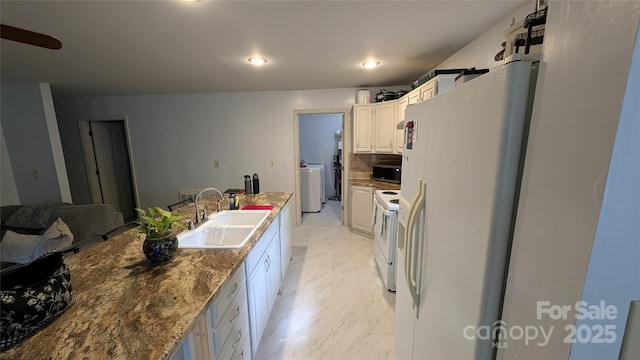 242 Upper Whitewater Rd, Sapphire, NC 28774 - kitchen with white appliances, washer / dryer, white cabinetry, light marble finish flooring, and backsplash