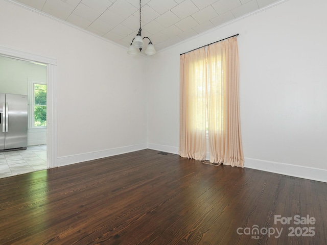 110 College St, Marshville, NC 28103 - unfurnished room featuring crown molding, a chandelier, and wood finished floors