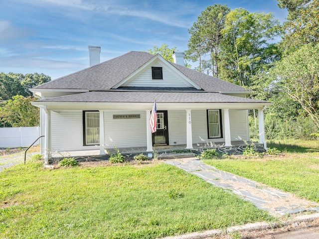 110 College St, Marshville, NC 28103 - view of front facade with covered porch, a shingled roof, and a chimney