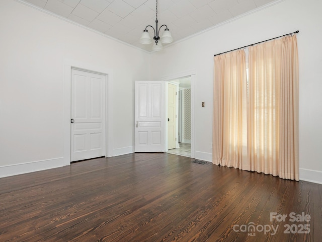 110 College St, Marshville, NC 28103 - empty room with a chandelier, ornamental molding, and dark wood-style floors