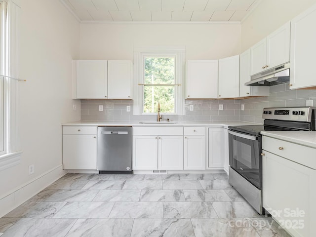 110 College St, Marshville, NC 28103 - kitchen featuring appliances with stainless steel finishes, under cabinet range hood, light countertops, white cabinets, and crown molding