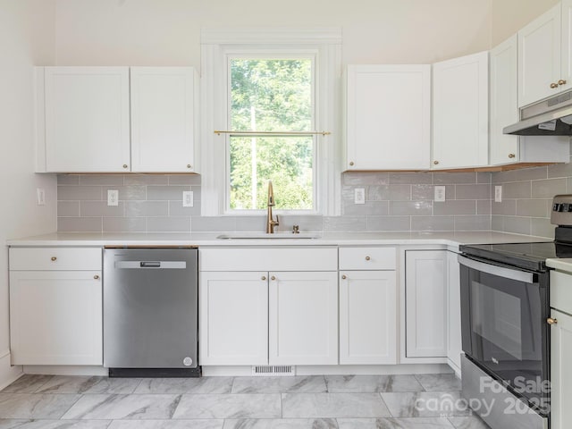 110 College St, Marshville, NC 28103 - kitchen with stainless steel appliances, under cabinet range hood, light countertops, white cabinets, and light marble finish floors