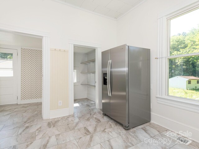 110 College St, Marshville, NC 28103 - kitchen featuring stainless steel fridge, crown molding, light marble finish floors, and plenty of natural light