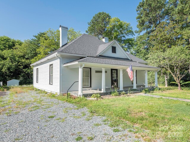 110 College St, Marshville, NC 28103 - view of front of property with a chimney, a shingled roof, a porch, and a front yard