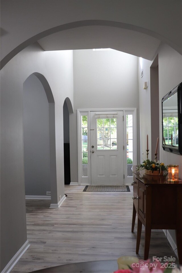 3092 S Legacy Park Blvd, Fort Mill, SC 29707 - foyer entrance featuring light wood finished floors, a high ceiling, and arched walkways