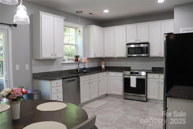 3092 S Legacy Park Blvd, Fort Mill, SC 29707 - kitchen featuring appliances with stainless steel finishes, decorative backsplash, white cabinets, decorative light fixtures, and recessed lighting