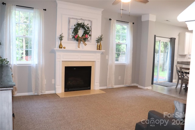 3092 S Legacy Park Blvd, Fort Mill, SC 29707 - unfurnished living room featuring carpet floors, a ceiling fan, a fireplace with flush hearth, and plenty of natural light