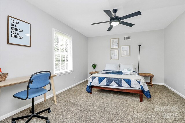 3909 Woodbriar Trl, Charlotte, NC 28205 - bedroom with an office area, carpet, and a ceiling fan