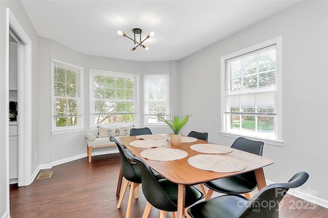 3909 Woodbriar Trl, Charlotte, NC 28205 - dining area featuring a chandelier, dark wood-style flooring, and healthy amount of natural light