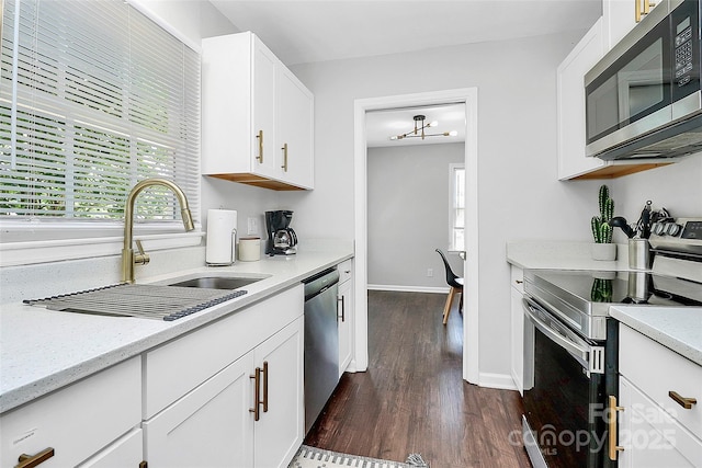 3909 Woodbriar Trl, Charlotte, NC 28205 - kitchen featuring stainless steel appliances, dark wood-style floors, white cabinets, and light stone countertops