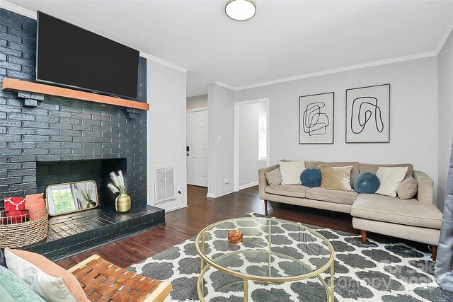 3909 Woodbriar Trl, Charlotte, NC 28205 - living area featuring wood finished floors, ornamental molding, and a fireplace