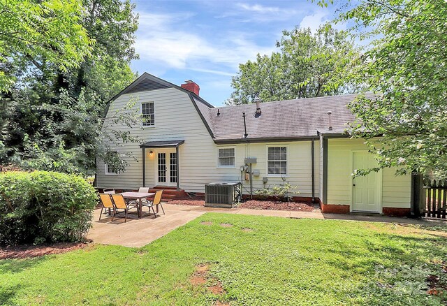 3909 Woodbriar Trl, Charlotte, NC 28205 - back of house featuring a patio area, a gambrel roof, a chimney, french doors, and a shingled roof