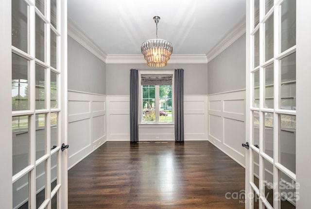 15603 June Washam Rd, Davidson, NC 28036 - unfurnished room with a chandelier, french doors, a decorative wall, ornamental molding, and dark wood finished floors