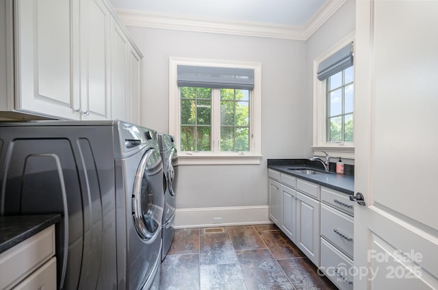 15603 June Washam Rd, Davidson, NC 28036 - washroom featuring cabinet space, independent washer and dryer, ornamental molding, and dark stone finish flooring