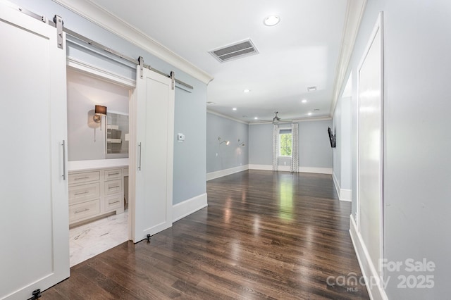 15603 June Washam Rd, Davidson, NC 28036 - unfurnished room featuring a barn door, ornamental molding, recessed lighting, and dark wood finished floors