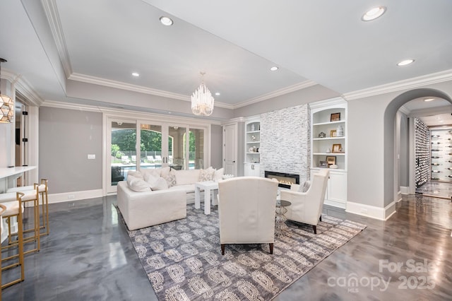 15603 June Washam Rd, Davidson, NC 28036 - living area featuring arched walkways, a large fireplace, recessed lighting, crown molding, and a chandelier