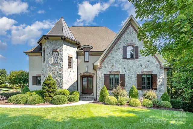 15603 June Washam Rd, Davidson, NC 28036 - french country inspired facade with stone siding, french doors, a standing seam roof, a front yard, and a metal roof