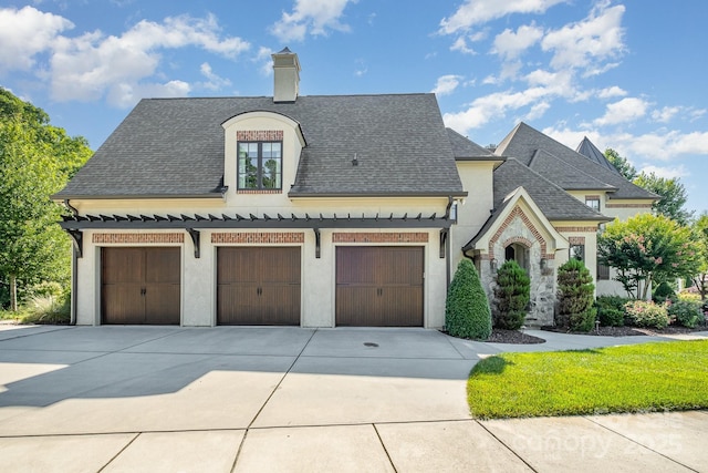 15603 June Washam Rd, Davidson, NC 28036 - french country home with driveway, a shingled roof, and a chimney