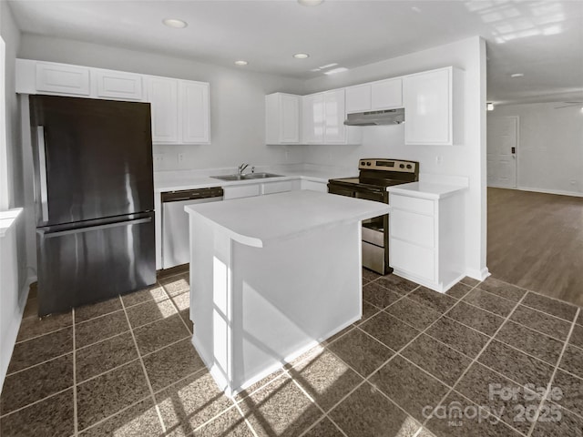 5163 Ficus Tree Ln, Charlotte, NC 28215 - kitchen featuring stainless steel appliances, under cabinet range hood, white cabinetry, recessed lighting, and a center island