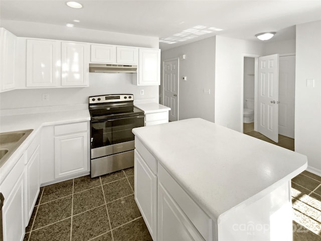5163 Ficus Tree Ln, Charlotte, NC 28215 - kitchen featuring electric range, under cabinet range hood, white cabinets, a kitchen island, and recessed lighting