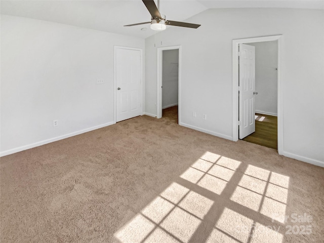 5163 Ficus Tree Ln, Charlotte, NC 28215 - unfurnished bedroom featuring carpet flooring, a spacious closet, lofted ceiling, and ceiling fan