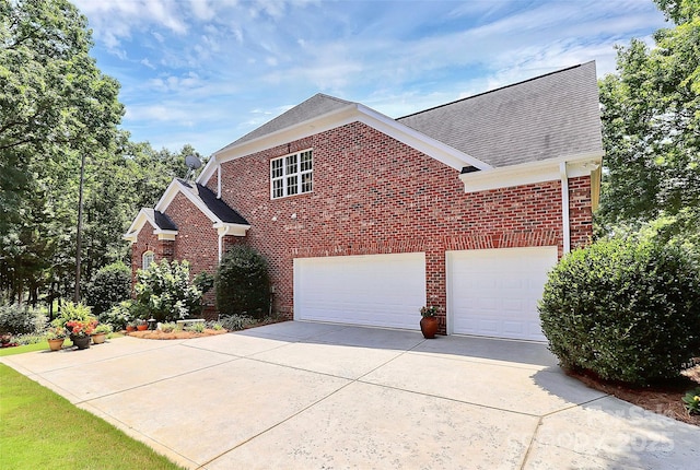 13824 Glen Abbey Dr, Charlotte, NC 28278 - view of front facade featuring concrete driveway, brick siding, and roof with shingles