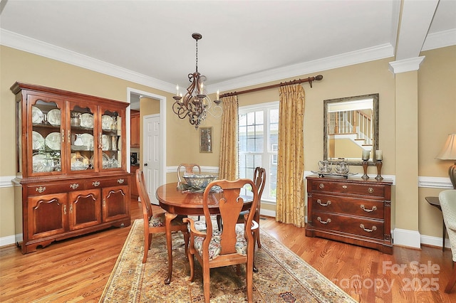 13824 Glen Abbey Dr, Charlotte, NC 28278 - dining area with a chandelier, ornamental molding, and light wood-style flooring