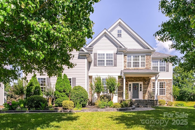 7737 Pleasant Valley Dr, Harrisburg, NC 28075 - view of front facade with stone siding and a front lawn