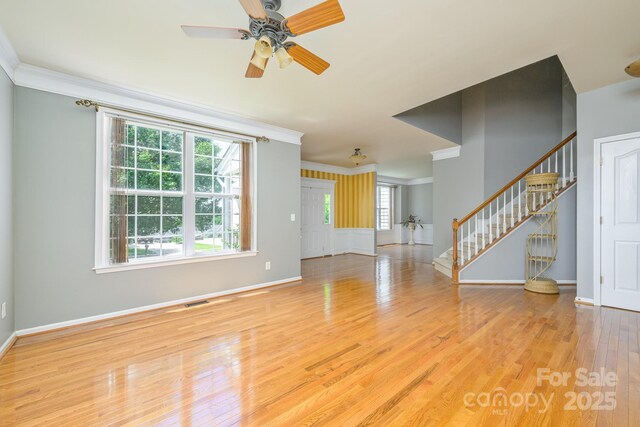 7737 Pleasant Valley Dr, Harrisburg, NC 28075 - unfurnished living room with ornamental molding, stairs, wood finished floors, and a ceiling fan