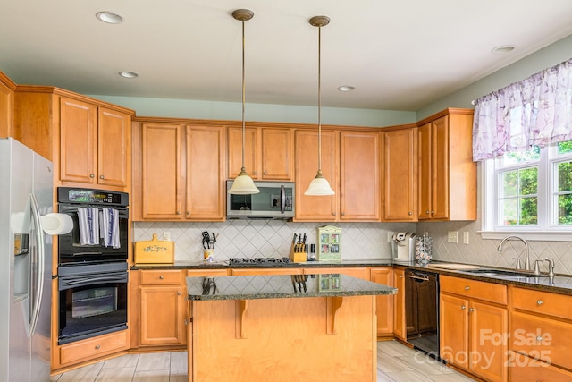 7737 Pleasant Valley Dr, Harrisburg, NC 28075 - kitchen featuring black appliances, a kitchen island, dark stone counters, a breakfast bar, and recessed lighting