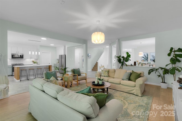 2926 Royal Fern Ln, Charlotte, NC 28215 - living room featuring stairs, light wood-style floors, and recessed lighting