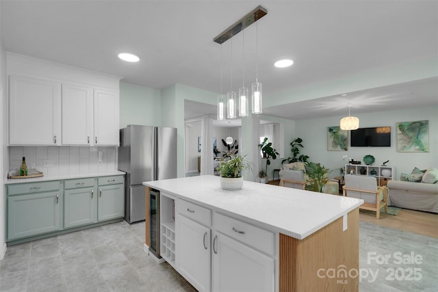 2926 Royal Fern Ln, Charlotte, NC 28215 - kitchen featuring freestanding refrigerator, open floor plan, light countertops, white cabinetry, and pendant lighting
