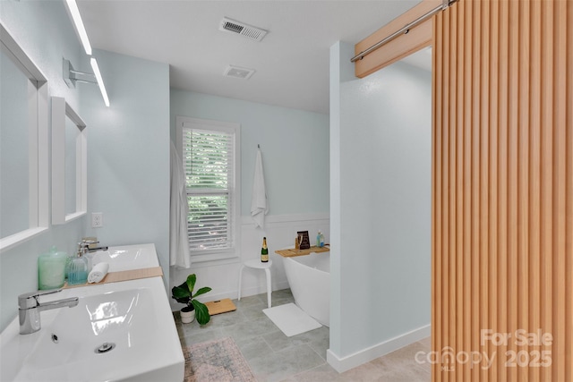 2926 Royal Fern Ln, Charlotte, NC 28215 - bathroom with a soaking tub, double vanity, and tile patterned floors