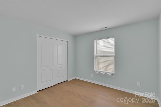 2926 Royal Fern Ln, Charlotte, NC 28215 - unfurnished bedroom with wood finished floors and a closet