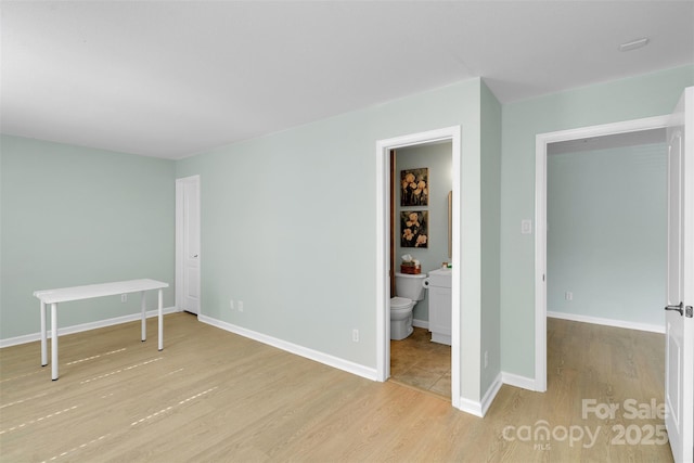 2926 Royal Fern Ln, Charlotte, NC 28215 - unfurnished bedroom featuring wood finished floors and ensuite bath