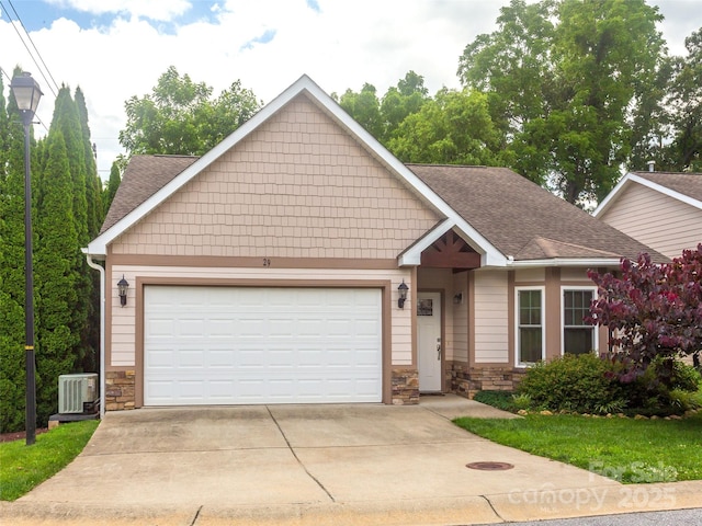 29 Kaylor Dr, Arden, NC 28704 - view of front facade featuring stone siding, an attached garage, roof with shingles, and driveway