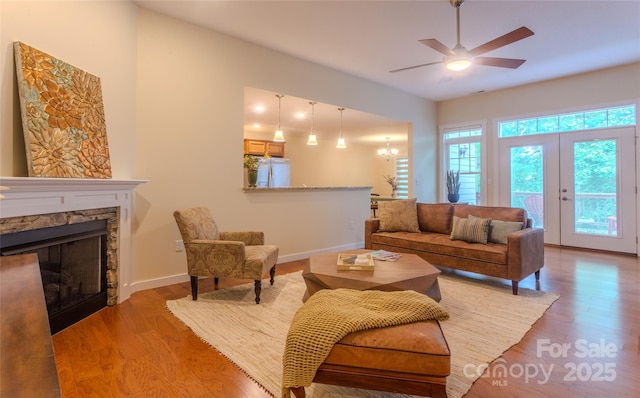 29 Kaylor Dr, Arden, NC 28704 - living room featuring wood finished floors, a ceiling fan, a stone fireplace, and a chandelier