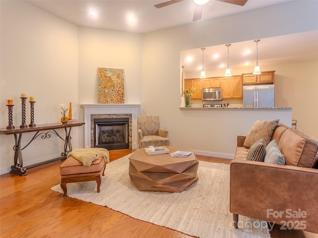 29 Kaylor Dr, Arden, NC 28704 - living room with a ceiling fan, light wood-type flooring, and a fireplace