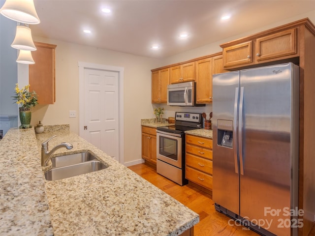 29 Kaylor Dr, Arden, NC 28704 - kitchen featuring stainless steel appliances, light wood-style flooring, light stone countertops, brown cabinets, and recessed lighting