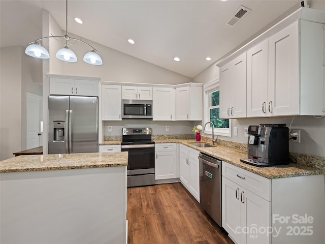 101 Meadowbrook Dr, Franklin, NC 28734 - kitchen featuring stainless steel appliances, lofted ceiling, white cabinets, dark wood-type flooring, and light stone counters