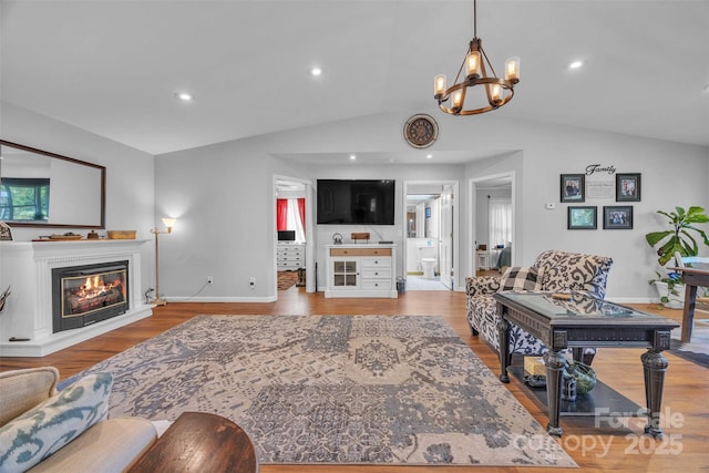 5158 Jenkins Rd, Morganton, NC 28655 - living area with lofted ceiling, light wood-style flooring, a chandelier, a glass covered fireplace, and recessed lighting