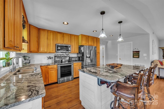 5158 Jenkins Rd, Morganton, NC 28655 - kitchen featuring appliances with stainless steel finishes, dark stone countertops, a kitchen bar, a center island, and recessed lighting