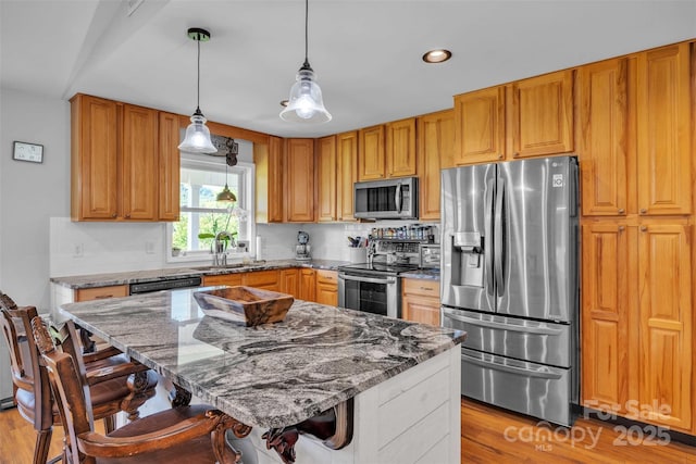 5158 Jenkins Rd, Morganton, NC 28655 - kitchen featuring stainless steel appliances, light stone counters, a breakfast bar area, light wood-style flooring, and recessed lighting