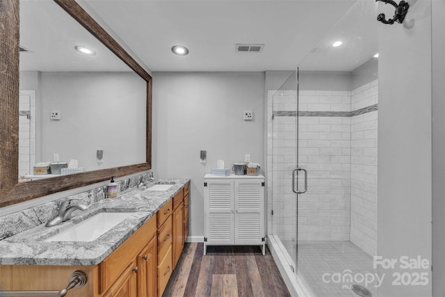 5158 Jenkins Rd, Morganton, NC 28655 - full bath with double vanity, a shower stall, wood finished floors, and recessed lighting
