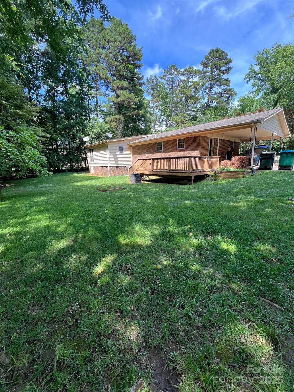 2300 Lakeview Cir Unit 10, Matthews, NC 28105 - rear view of property with a wooden deck, a lawn, and brick siding