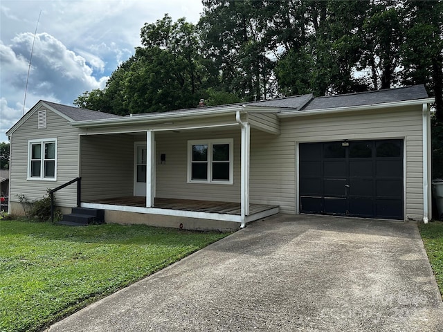1116 Lenoir Ave SW, Lenoir, NC 28645 - view of front of house featuring driveway, an attached garage, a front lawn, and covered porch