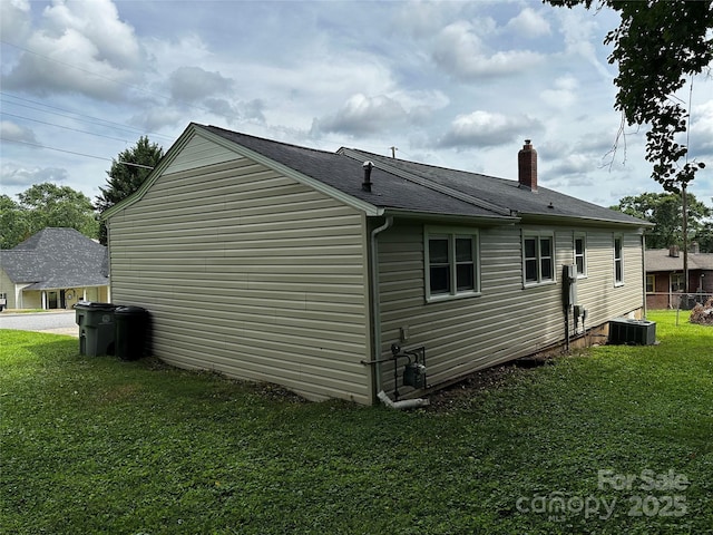 1116 Lenoir Ave SW, Lenoir, NC 28645 - view of property exterior featuring a yard, a chimney, and roof with shingles