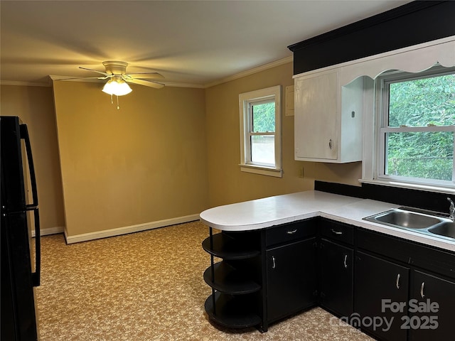 1116 Lenoir Ave SW, Lenoir, NC 28645 - kitchen featuring dark cabinets, freestanding refrigerator, light countertops, a ceiling fan, and a peninsula