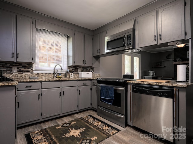 69 Katydid Dr, Marion, NC 28752 - kitchen featuring appliances with stainless steel finishes, gray cabinets, healthy amount of natural light, and decorative backsplash