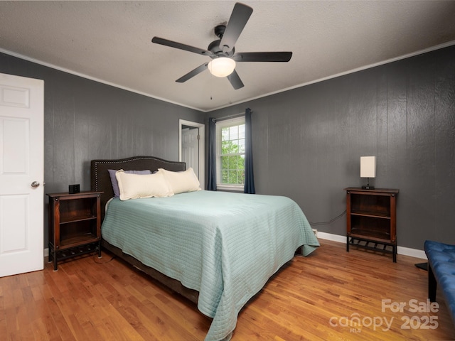 69 Katydid Dr, Marion, NC 28752 - bedroom with wood finished floors, crown molding, a ceiling fan, and wooden walls